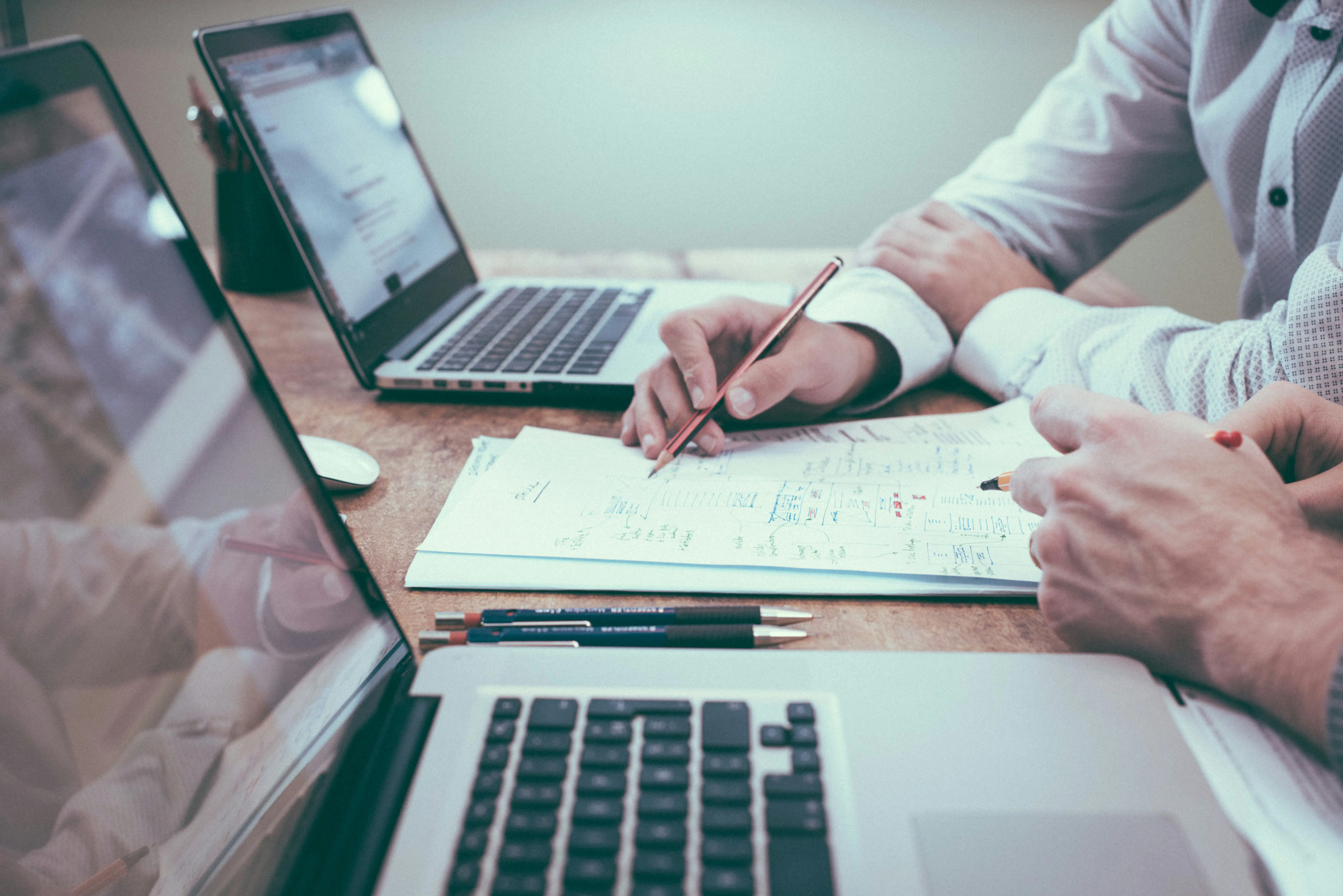 Accountants reviewing client financials for insolvency referral