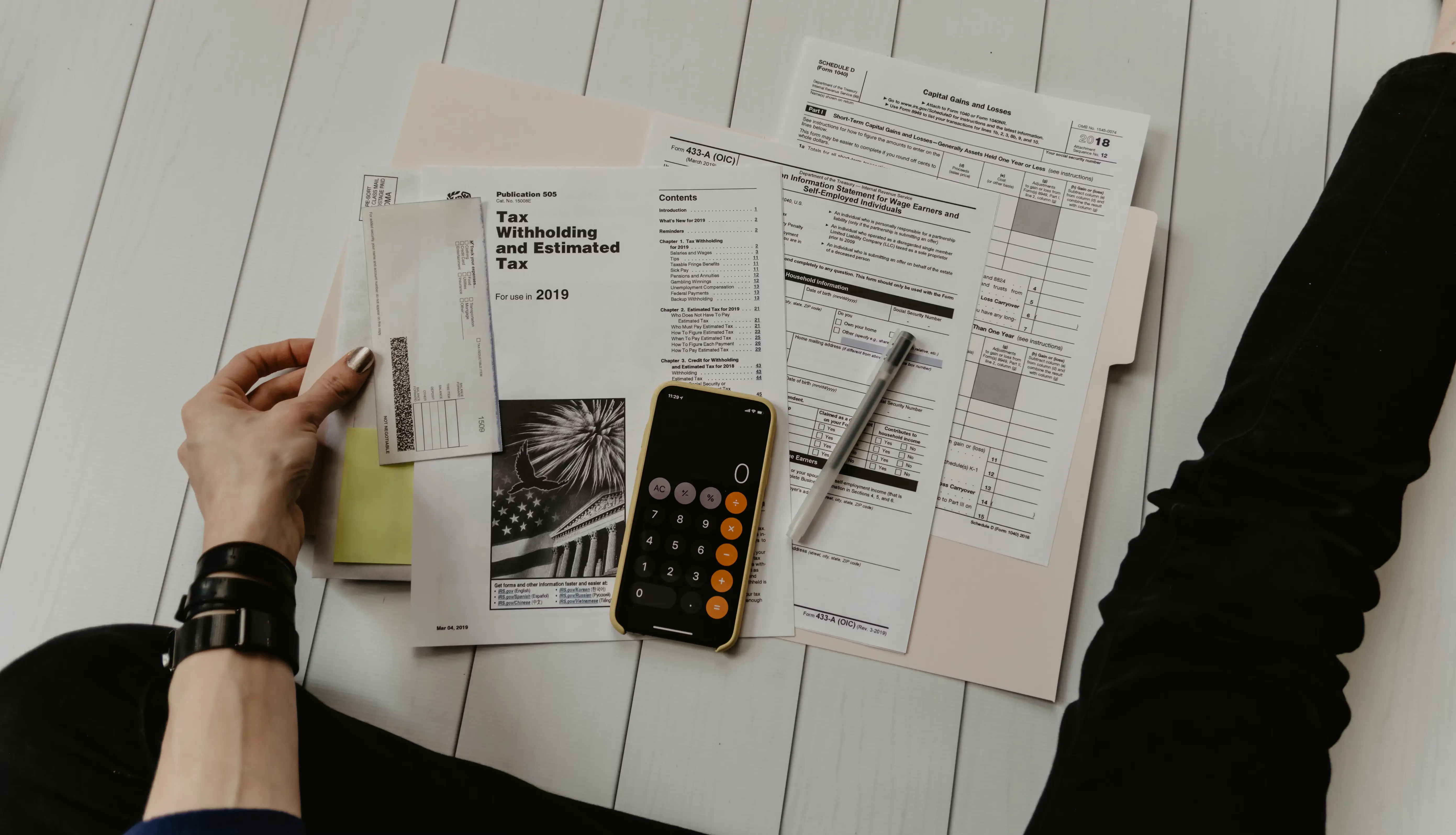 HMRC tax arrears demand letters and calculator on a desk