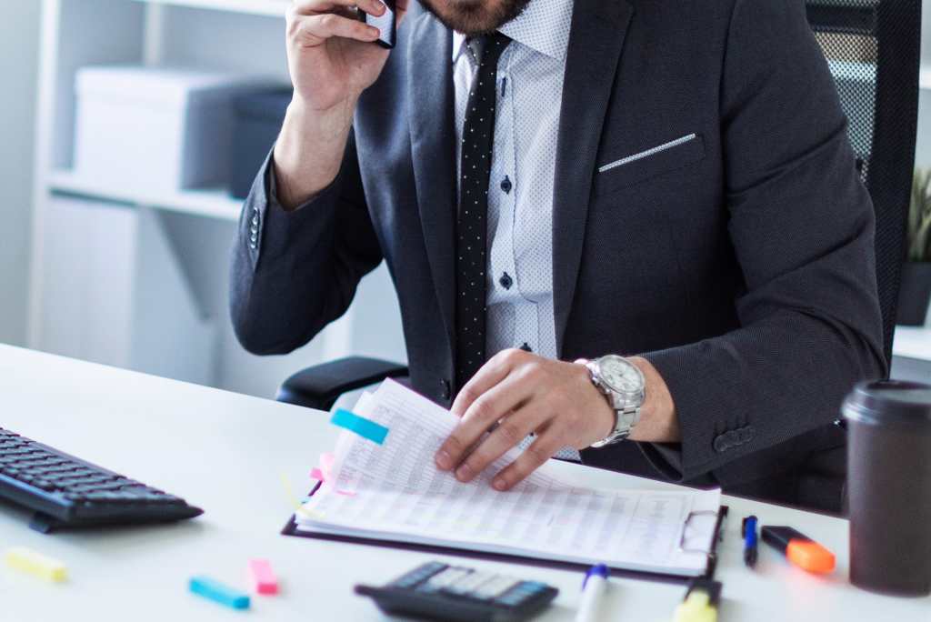 Company director reviewing HMRC COP9 investigation letter with legal adviser